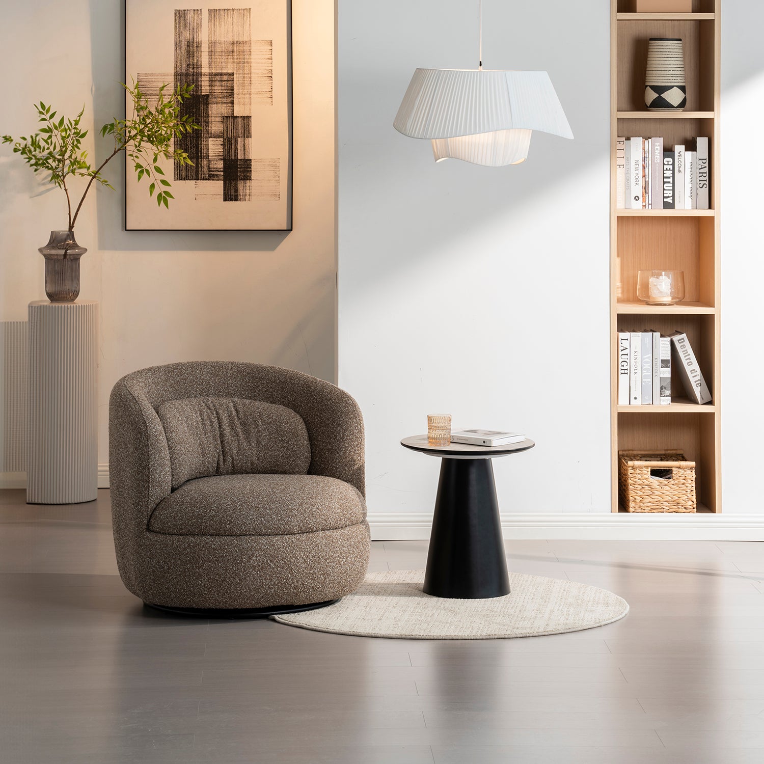 Sillón Victoria con mesa lateral color negro, con un vaso de agua y un libro.
debajo de un cuadro artistico, con pared blancas y una mesa lateral con un florero